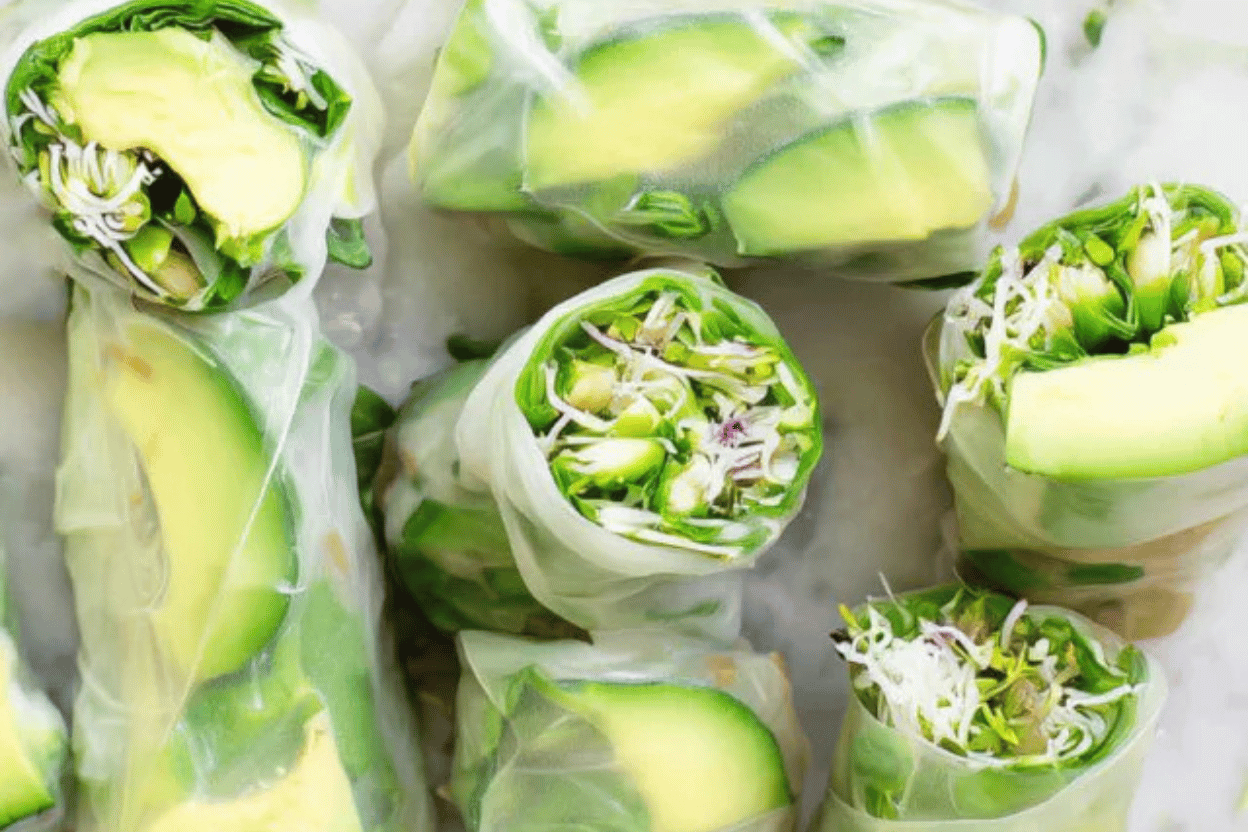 Fresh spring rolls filled with avoacado slices and sprouts.