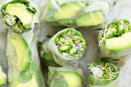 Fresh spring rolls filled with avoacado slices and sprouts.